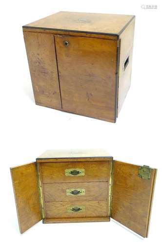 A small late 19thC oak and walnut cased military campaign chest with twin brass recessed handles,