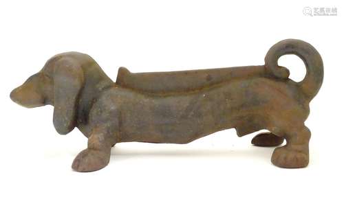 A late 20thC cast iron boot scraper modelled as a dachshund / sausage dog. Approx. 14 1/2