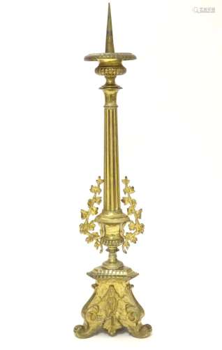 A 20thC large ecclesiastical gilded pricket candlestick with a fluted column flanked by applied vine
