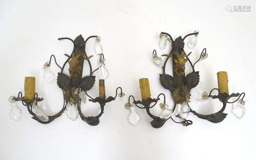 A pair of early 20thC Continental wall lights, decorated with gilt goat heads and patinated