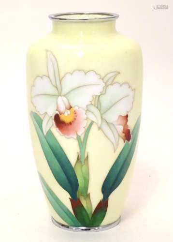 A Japanese enamel cloisonne vase of ovoid form decorated with iris flowers on a pale yellow