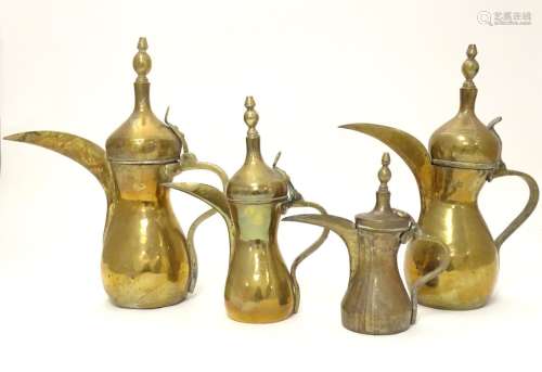 Four Middle Eastern brass Dallah coffee pots of varying sizes with impressed and banded detail.