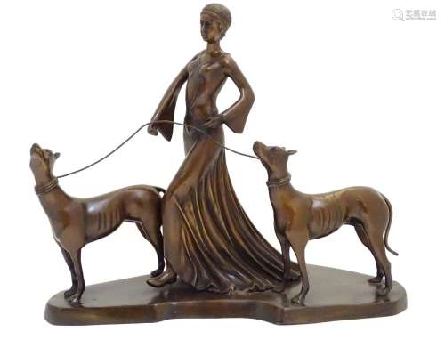 A 20thC bronze sculpture modelled as a lady walking two dogs. Approx. 17