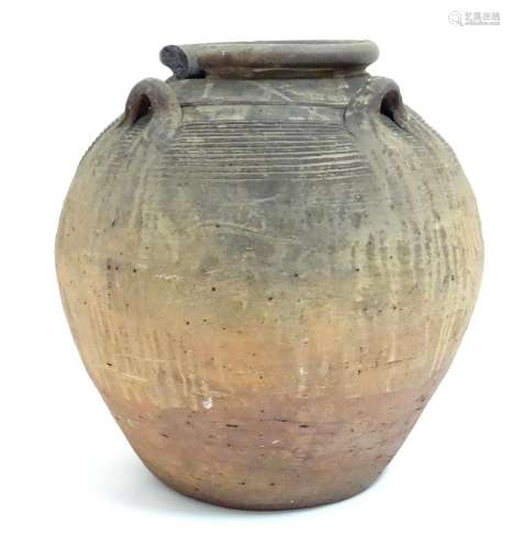 An antique clay pot / vase with loop handles and incised banded detail. Approx. 14 1/2