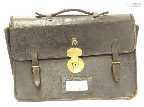 A 20thC black leather briefcase with EIIR (Elizabeth II Regina) and crown gilt insignia. Approx. 16