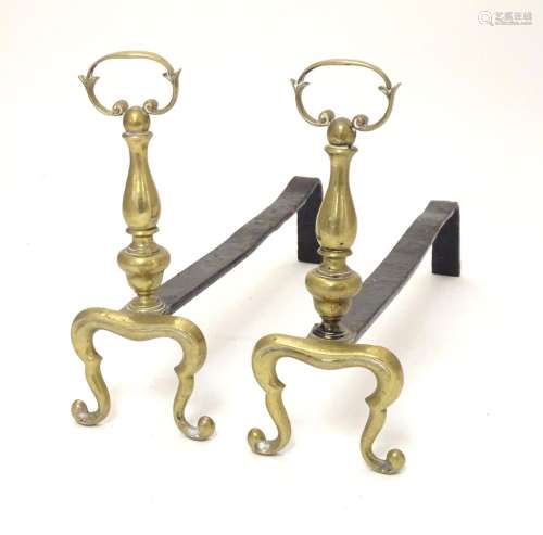 A pair of 19thC fire dogs of brass and iron construction. Approx. 16