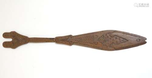 Ethnographic / Native / Tribal: A carved wooden ceremonial paddle formed as a stylised fish with