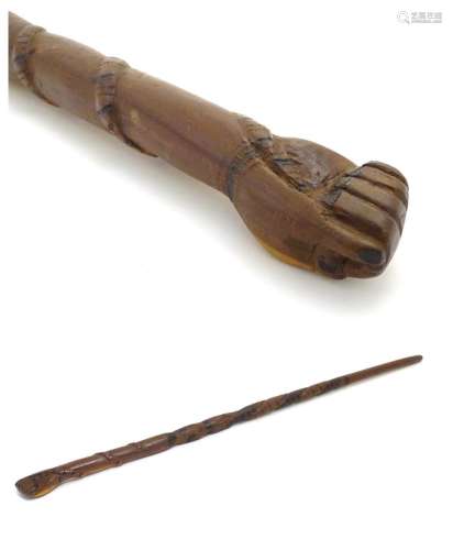 An early 20thC Australian blackwood walking cane, the knop formed as a clenched fist holding a