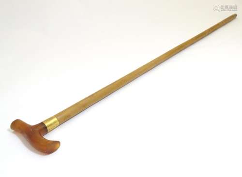 An early to mid-20thC Brigg walking stick, with 18ct gold band, amber Bakelite handle, malacca shaft