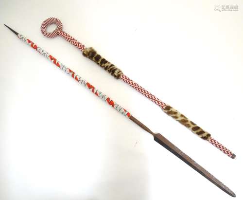 An African native tribal spear and walking stick, each with beadwork decoration, the stick with