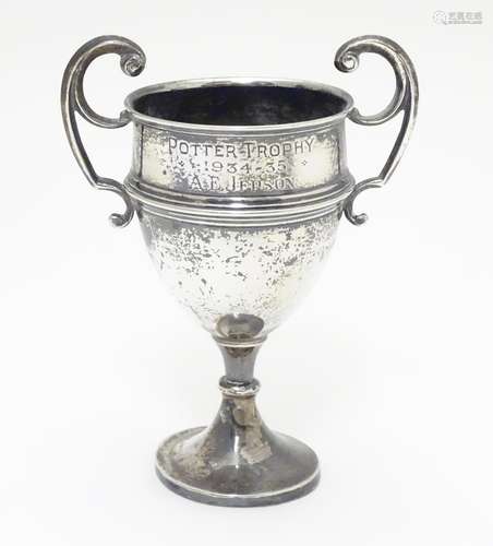 A silver pedestal trophy cup with twin handles. hallmarked Sheffield 1935 maker James Edward