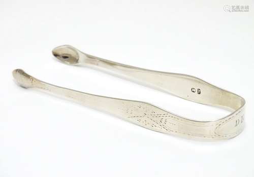 Geo III silver sugar tongs with bright cut decoration. Maker Hester Bateman. Late 18thC . Approx 5