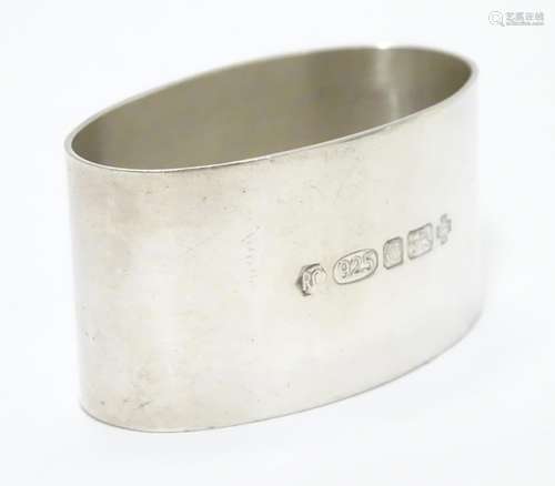 A silver napkin ring of oval form. Hallmarked London 2000 maker Carr's of Sheffield Ltd. Please Note