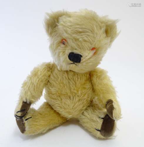 Toy: A mohair teddy bear with articulated limbs, pad paws, stitched claws, and a proud, stitched