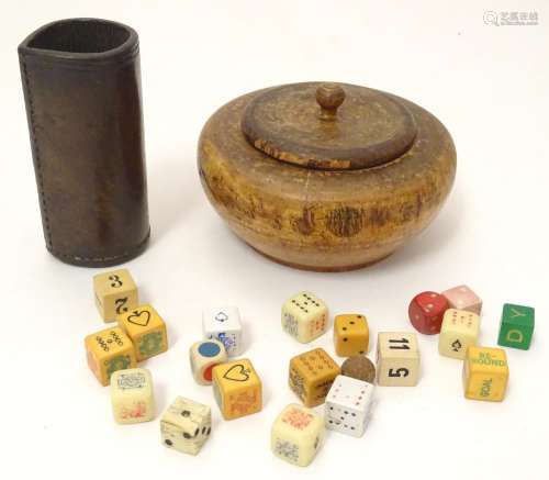 Toys: A treen 19thC turned fruitwood pot and cover containing an assortment of dice, together with a