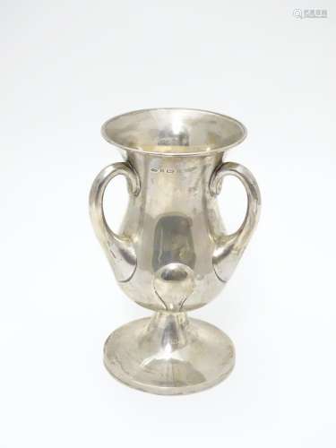 An Art Nouveau silver pedestal trophy cup with three handles. hallamrked Bimirngham 1902 maker
