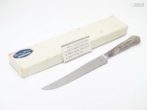 A silver handled cake knife hallmarked Sheffield 1975. Harrison Brothers 10