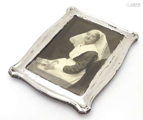A photograph frame with silver surround. Hallmarked Birmingham 1912 maker Jones & Crompton. 7