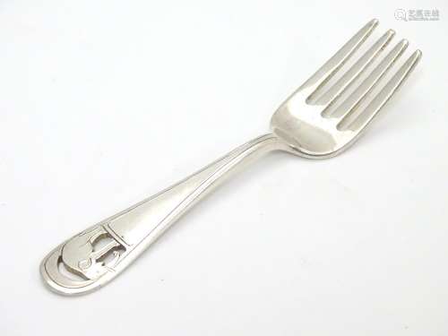 An American Arts and Crafts sterling silver small fork. Having pierced and engraved design of an