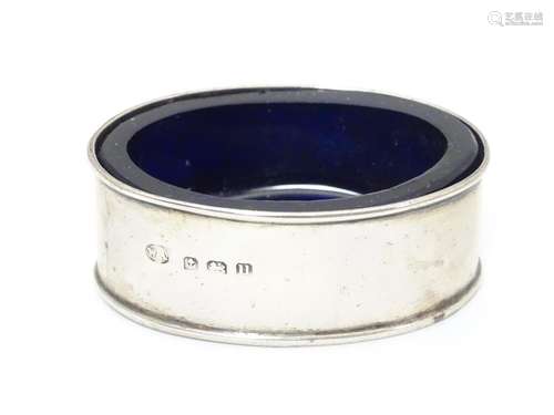 A silver salt of oval form with blue glass liner. Hallmarked 1919 maker William Aitken. 2 1/4