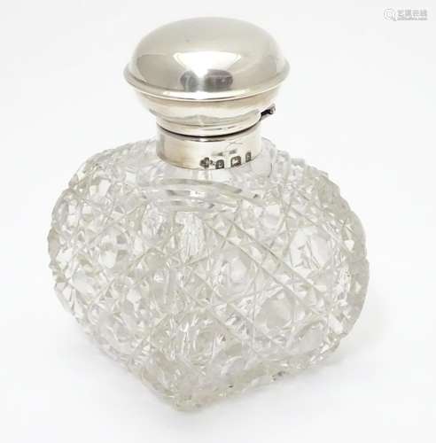 A cut glass scent / perfume bottle with silver top hallmarked Birmingham, 1930 maker William