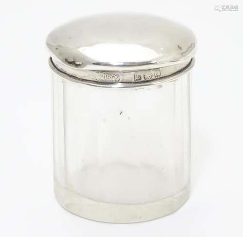 A glass dressing table pot with silver top hallmarked Birmingham 1905 maker M bros. 2