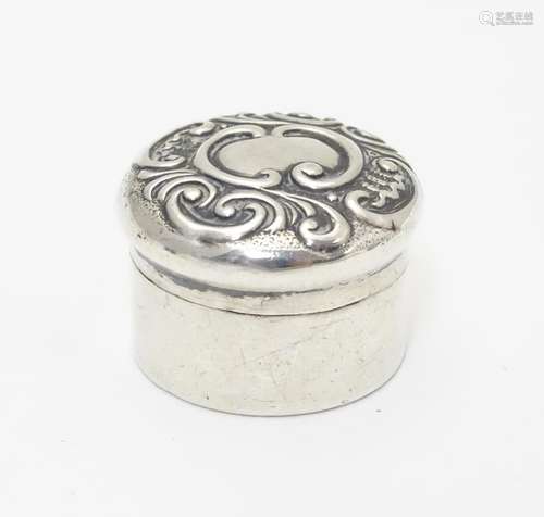 A small silver box of circular form with embossed decoration to lid. Hallmarked Birmingham 1902