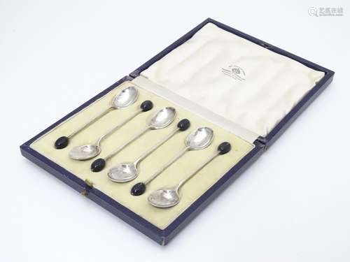 A cased set of 6 silver coffee spoons with coffee bean decoration to handles. Hallmarked