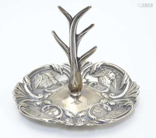 A silver ring tree, the base with winged cherub decoration. Hallmarked Birmingham 1906 maker Henry