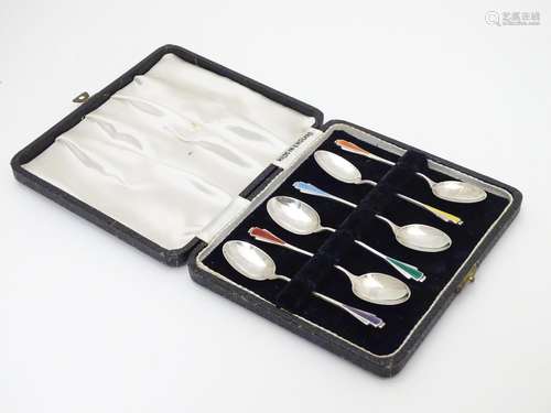 A cased set of 6 Art deco silver teaspoons with coloured guilloche enamel decoration to handles.