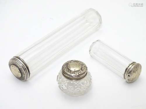 A collection of three silver lidded glass dressing table/vanity bottles. Hallmarked London 1890