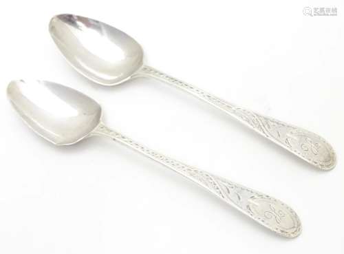 A pair of Geo III Old English pattern teaspoons with bright cut decoration to handles. Hallmarked