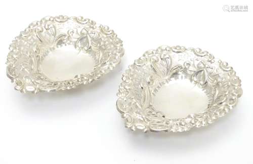 A pair of late Victorian silver heart-shaped bonbon dishes with pierced and scroll decoration,