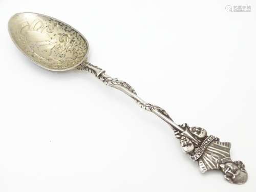 A silver souvenir spoon, the leaf surrounded handle surmounted by a bust of William Shakespeare over