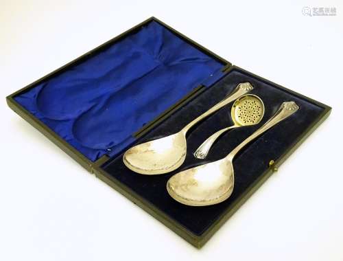 A cased serving / Strawberry set , the servers with hammered decoration together with a sifter