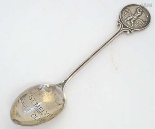 A silver spoon the handle surmounted by image of a golfer and the bowl engraved St. Melyd Golf Club.