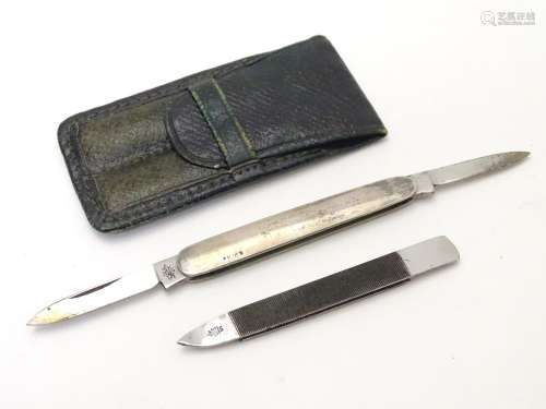 A green leather pouch containing a file and folding twin blade knife, marked 'Silver'. The case 23/