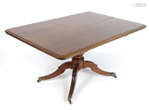 A late 19thC mahogany breakfast table with a rectangular moulded top above four sabre legs