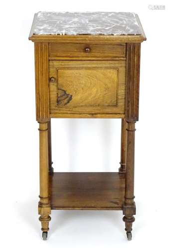 A late 19thC rosewood bedside cabinet with a marble inset top, single short drawer and cupboard