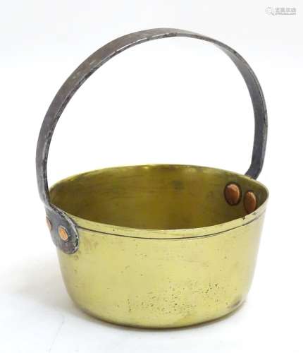 A 19thC small brass caramel pan, with fixed cast iron handle, 5 5/8