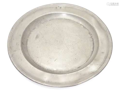 A pewter plate / charger stamped to rim IHA, and stamped with touch marks under. 15