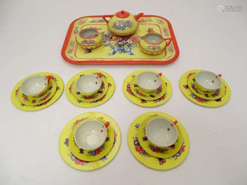 Toys: A mid 20thC Chad Valley tinplate tea set in bright yellow decorated with sprays of flowers and