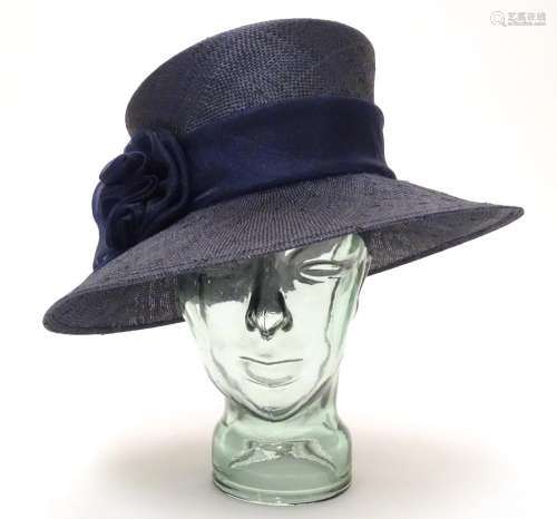 A ladies navy hat Please Note - we do not make reference to the condition of lots within