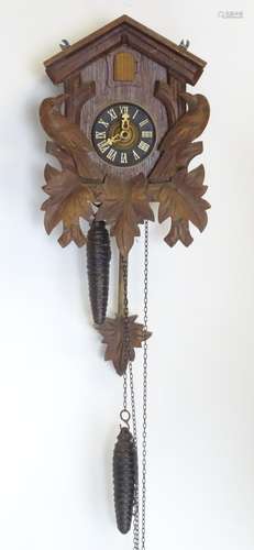 A mid - late 20thC cuckoo clock, with ' Regula 'movement and 2 cast pine cone fomred weights.