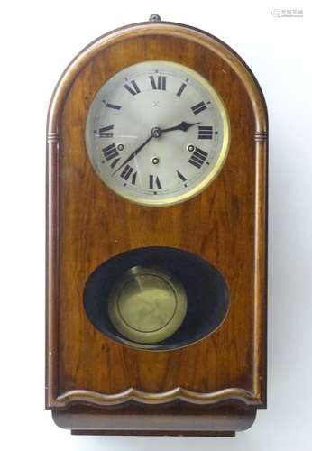 An early to mid 20thC wall clock, the arch top mahogany case with glazed sections, the 7