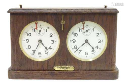 A 1920's / 30's oak cased chess clock by HAC Hamburg American Clock Company with crossed arrows