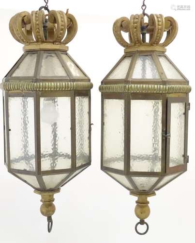 Two late 19thC / early 20thC gilt metal pendant lights of octagonal lantern form with crowns