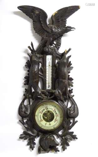 A late 19thC Black Forest barometer, the carved wooden case decorated with eagle, hanging game (