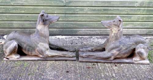 Garden & Architectural, Salvage: a pair of stone garden ornaments formed as couchant hounds / dogs