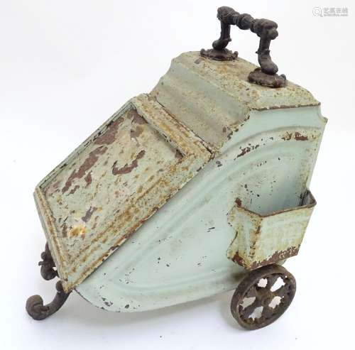 A Victorian tin coal scuttle, the base with wheels and stand, 21